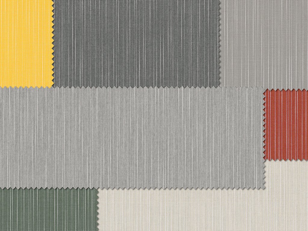Textiloberfläche mit verschiedenen geometrischen Farbfeldern in Gelb, Schwarz, Grau, Rot und Grün. Textiloberfläche mit verschiedenen geometrischen Farbfeldern in Gelb, Schwarz, Grau, Rot und Grün.